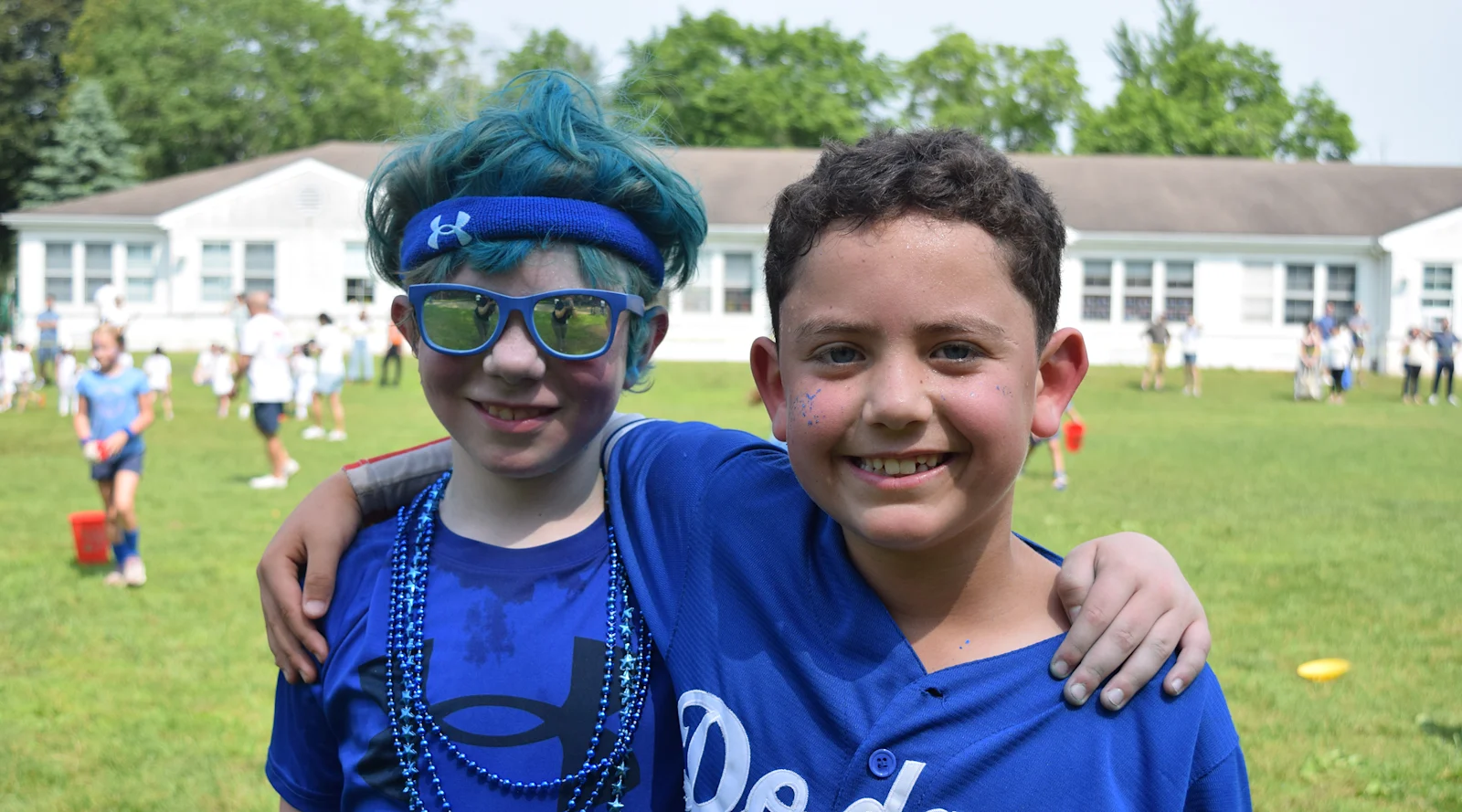 friends in blue spirit wear grin during field day