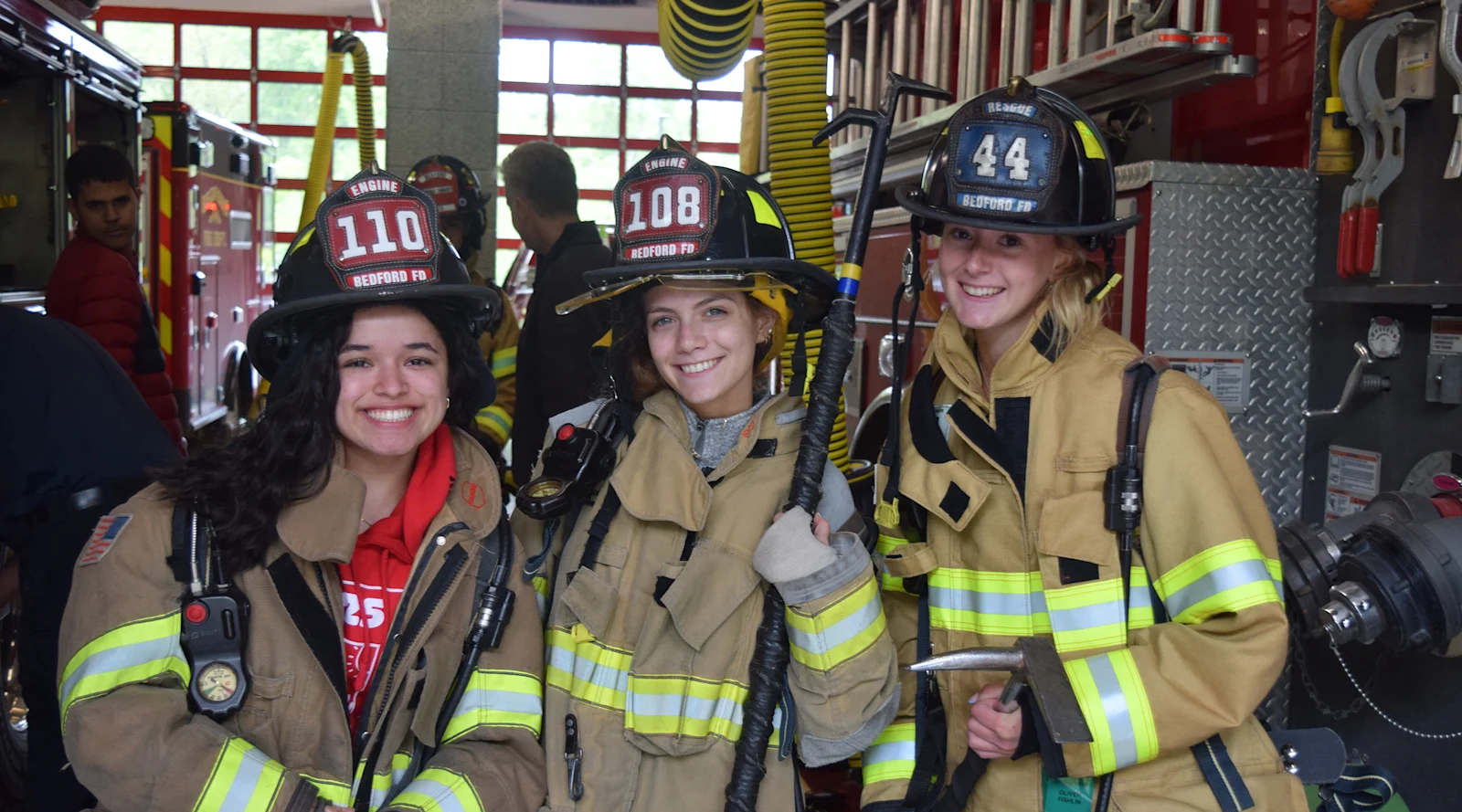 students wear firefighter gear on Community Volunteer Day